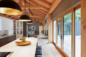 Interior flooded with natural light from floor-to ceiling windows in The Avon House, designed by Fusion Designed Interiors.
