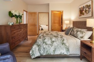 Serene bedroom in Stillwater, MN condo, featuring minimalist design by Fusion Designed Interiors.