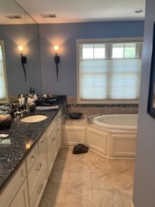 Innovative storage solutions in an accessible bathroom design by Fusion Designed Interiors.