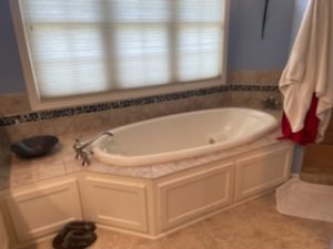 Eco-friendly bathroom design emphasizing holistic and sustainable elements by Fusion Designed Interiors.